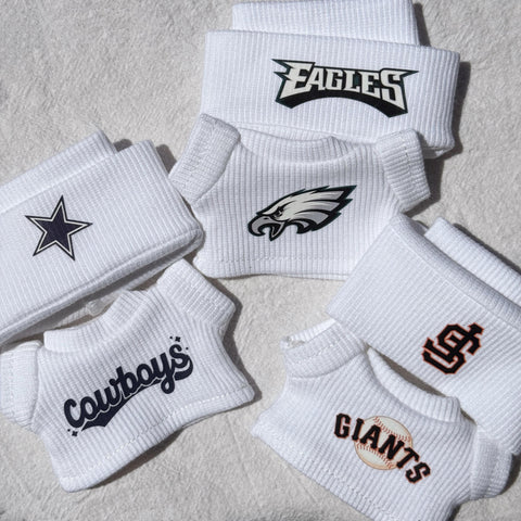 Labubu dressed in SF Giants, Dallas Cowboys, Buffalo Bills outfit with beanies.